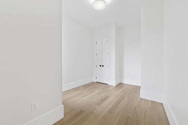 spare room with light wood-type flooring and baseboards