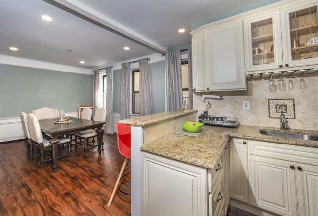 53 Duncan Ave Unit 31, Jersey City, NJ 07304 - kitchen featuring dark wood-style flooring, decorative backsplash, light stone countertops, a peninsula, and recessed lighting