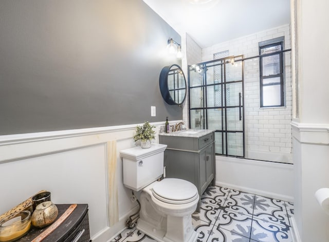 53 Duncan Ave Unit 31, Jersey City, NJ 07304 - bathroom featuring vanity, bath / shower combo with glass door, tile patterned floors, and a wainscoted wall