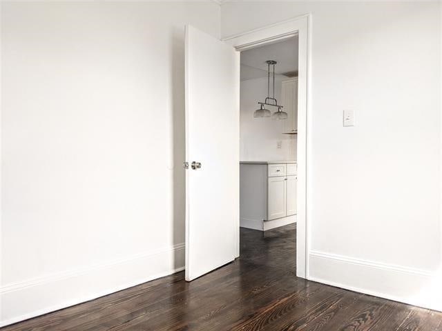 spare room featuring dark hardwood / wood-style floors