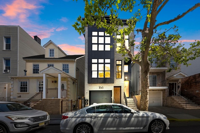 166 New York Ave Unit 2, Jersey City, NJ 07307 - view of front of home with an attached garage, stairs, and brick siding