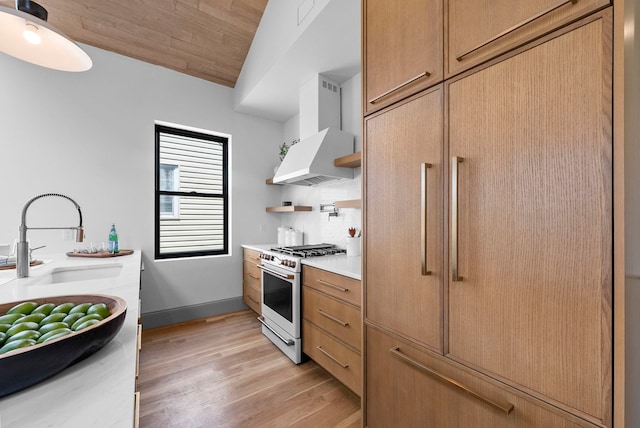 166 New York Ave Unit 2, Jersey City, NJ 07307 - kitchen with wall chimney exhaust hood, white range with gas cooktop, open shelves, light countertops, and light wood-type flooring