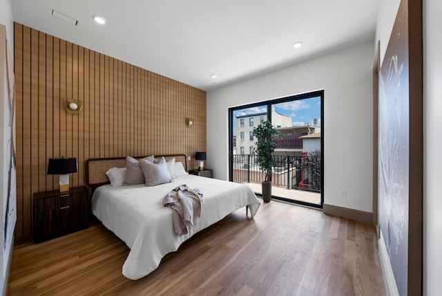 166 New York Ave Unit 2, Jersey City, NJ 07307 - bedroom featuring access to outside, wood finished floors, recessed lighting, and an accent wall