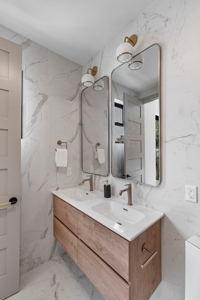 166 New York Ave Unit 2, Jersey City, NJ 07307 - full bathroom featuring double vanity, marble tiled flooring, and tile walls