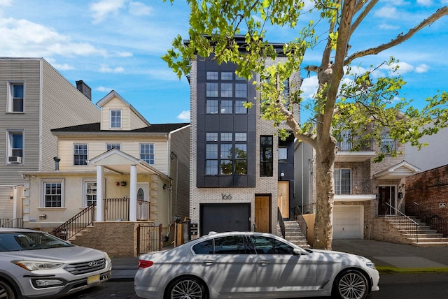 166 New York Ave Unit 2, Jersey City, NJ 07307 - view of property featuring a garage, stairs, and driveway