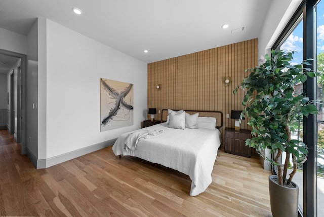 166 New York Ave Unit 2, Jersey City, NJ 07307 - bedroom featuring an accent wall, light wood finished floors, and recessed lighting