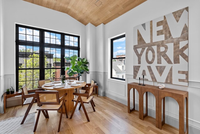 166 New York Ave Unit 2, Jersey City, NJ 07307 - dining space with plenty of natural light, light wood-type flooring, a wainscoted wall, vaulted ceiling, and a decorative wall
