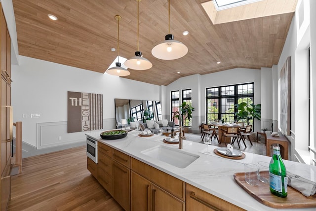 166 New York Ave Unit 2, Jersey City, NJ 07307 - kitchen featuring wood ceiling, lofted ceiling, a skylight, open floor plan, and light wood-style floors