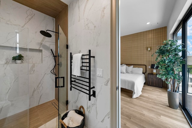 166 New York Ave Unit 2, Jersey City, NJ 07307 - full bathroom featuring a marble finish shower, a towel warming rack, wood finished floors, connected bathroom, and recessed lighting