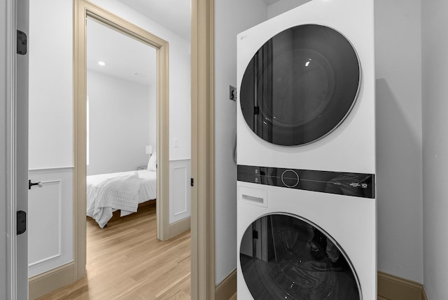 166 New York Ave Unit 2, Jersey City, NJ 07307 - laundry area featuring stacked washer and clothes dryer and light wood-style flooring