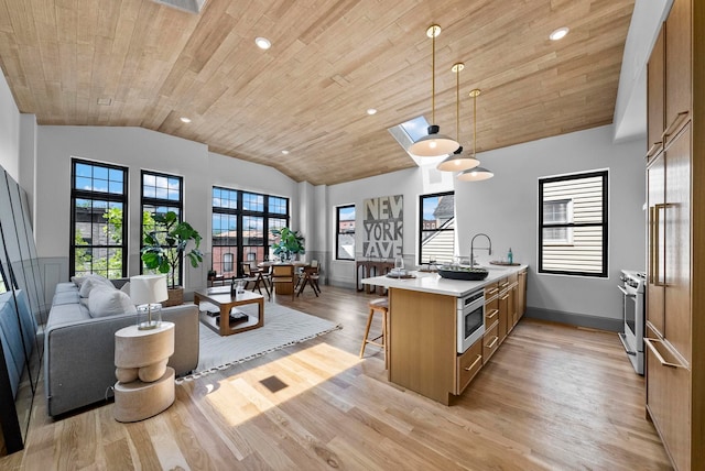 166 New York Ave Unit 2, Jersey City, NJ 07307 - kitchen featuring lofted ceiling, a kitchen bar, wooden ceiling, a peninsula, and light wood-style floors