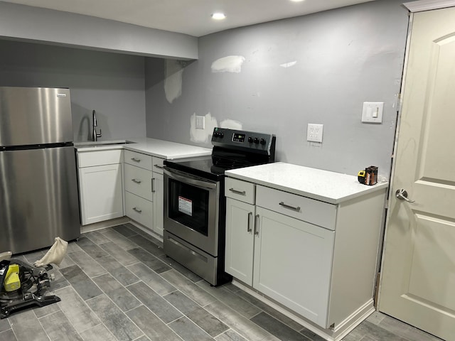 kitchen with white cabinetry, appliances with stainless steel finishes, and sink