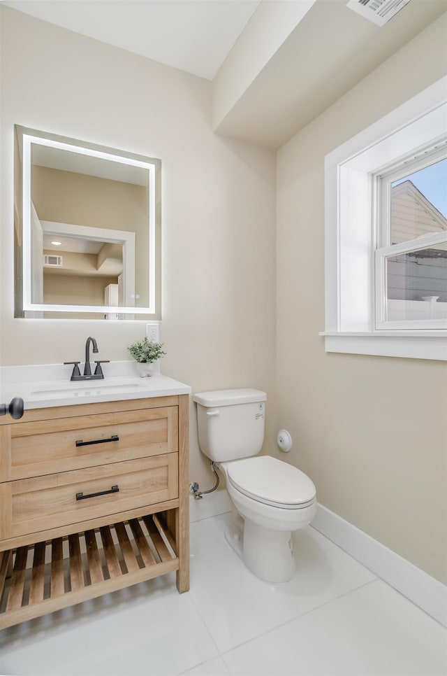 bathroom with visible vents, vanity, toilet, and tile patterned floors