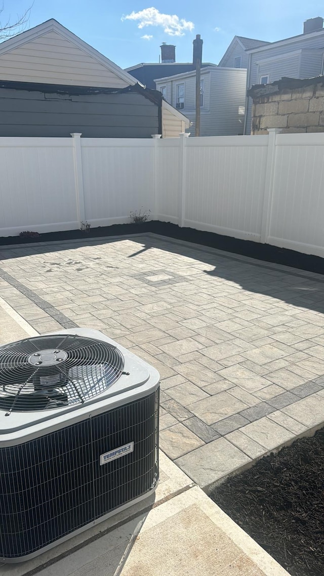 view of patio / terrace featuring fence and central AC unit