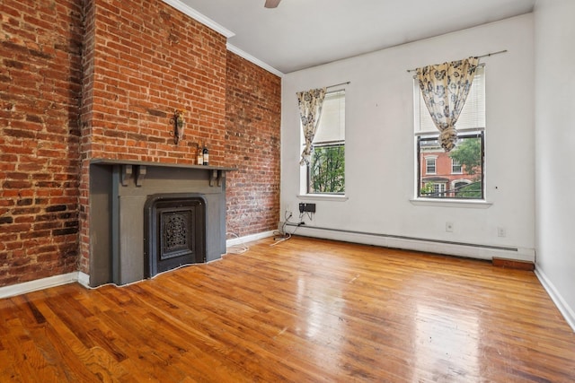 315 Pavonia Ave Unit 3, Jersey City, NJ 07302 - unfurnished living room featuring a baseboard radiator, wood finished floors, a fireplace, brick wall, and ornamental molding