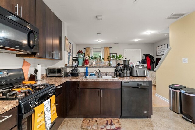 437 Rose Ave, Jersey City, NJ 07305 - kitchen featuring black appliances, a sink, a peninsula, and dark brown cabinetry
