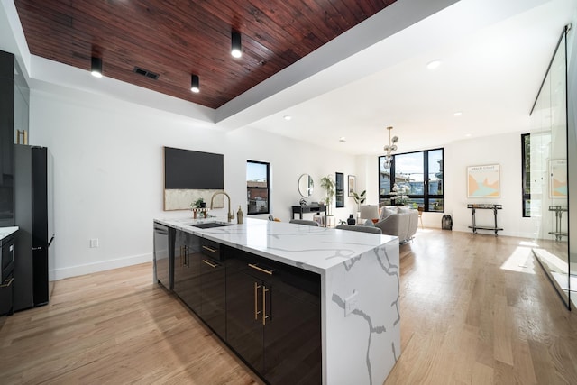 kitchen featuring visible vents, light wood-style flooring, wooden ceiling, stainless steel dishwasher, and a sink