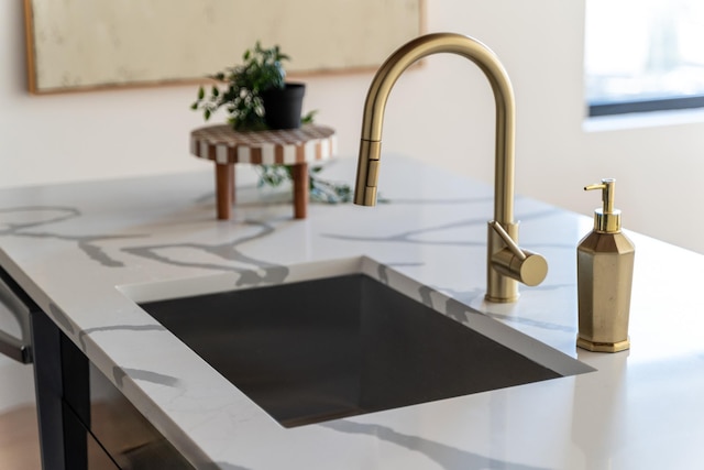 room details featuring stone countertops and a sink