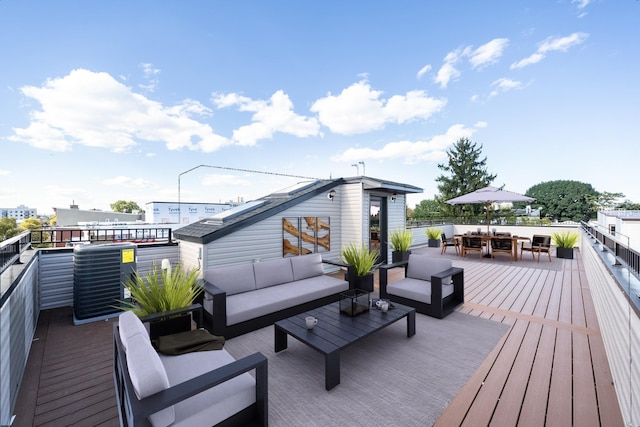 wooden terrace featuring outdoor lounge area and outdoor dining space