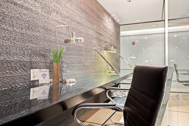 home office featuring wood walls and tile patterned flooring