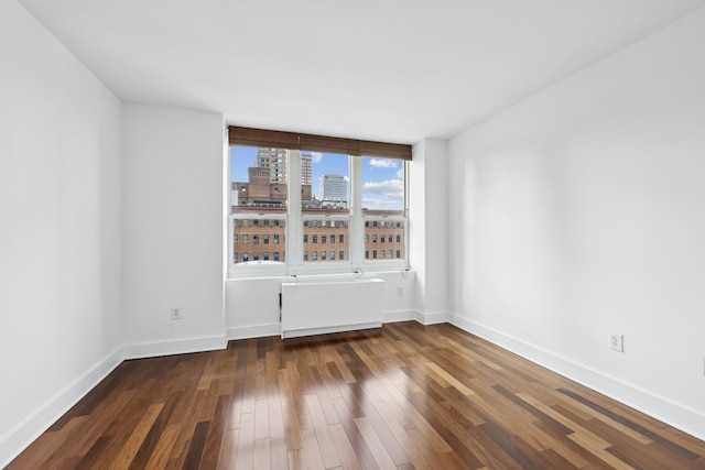 empty room with dark hardwood / wood-style floors