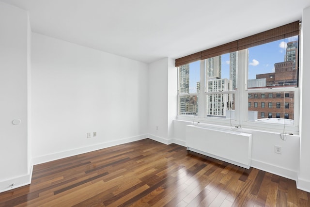 spare room with dark hardwood / wood-style flooring