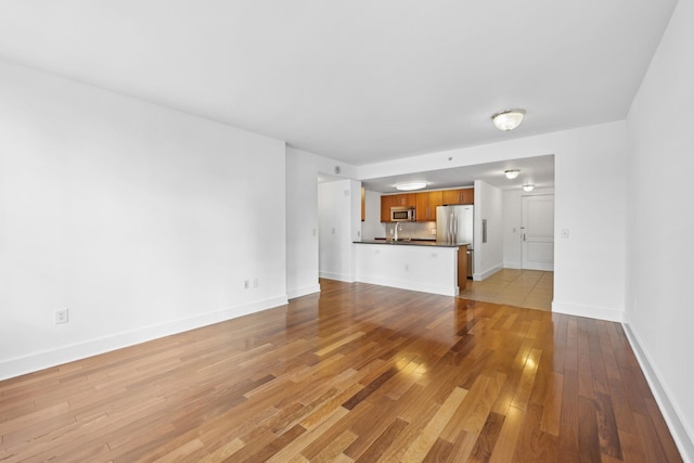 unfurnished living room with light hardwood / wood-style flooring