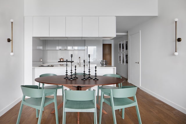 dining space with dark hardwood / wood-style flooring