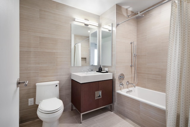 full bathroom with shower / bath combination with curtain, tile patterned floors, vanity, tile walls, and toilet