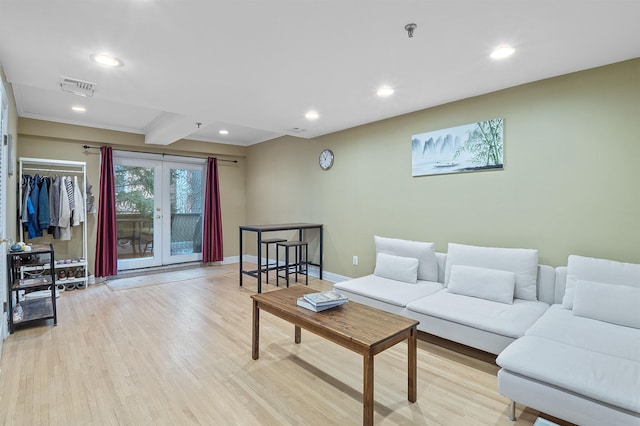 living room with french doors, light hardwood / wood-style flooring, and beamed ceiling