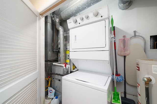 laundry area featuring stacked washer / dryer and water heater