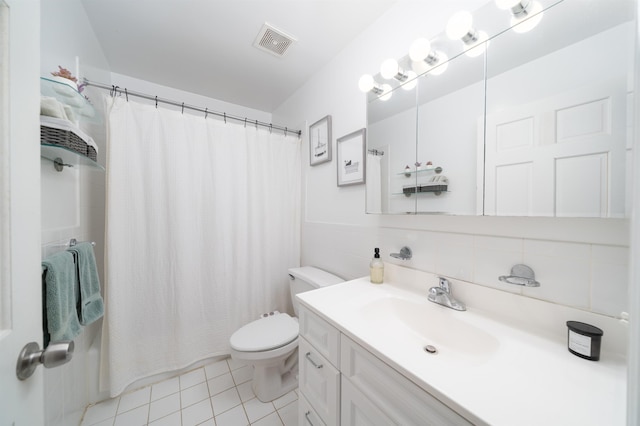 full bathroom with toilet, vanity, and tile patterned floors