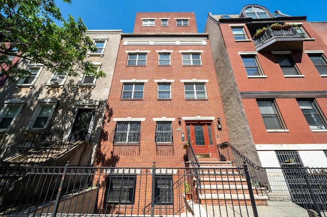 view of apartment building / complex with a fenced front yard
