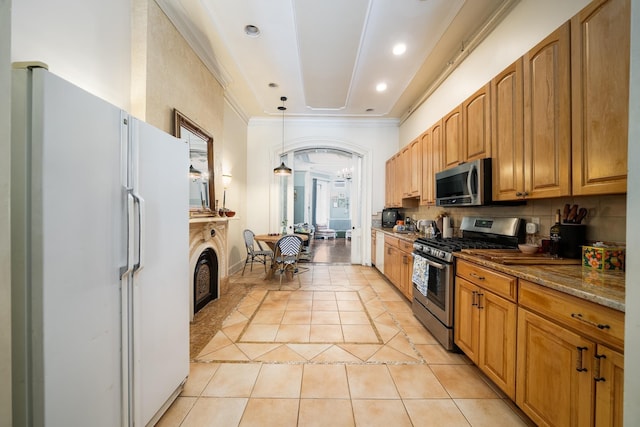 661 Jersey Ave Unit 2, Jersey City, NJ 07302 - kitchen featuring stainless steel appliances, light tile patterned flooring, tasteful backsplash, dark stone counters, and decorative light fixtures
