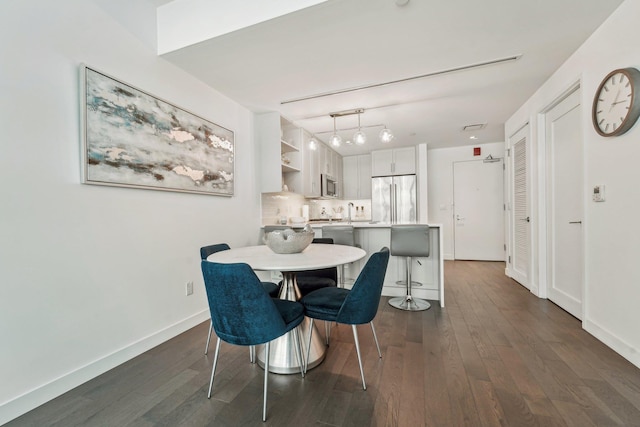 dining area featuring dark hardwood / wood-style flooring