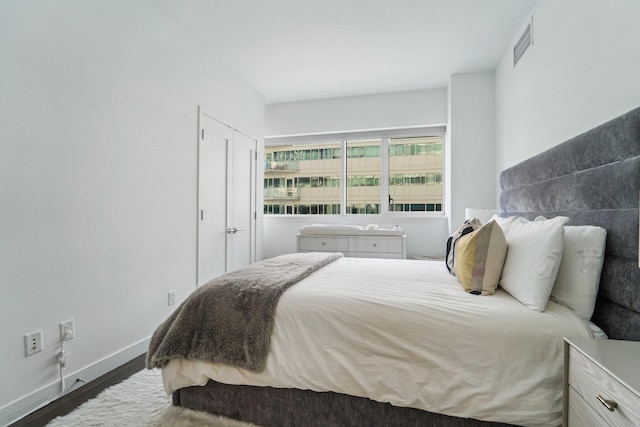 bedroom with dark hardwood / wood-style floors