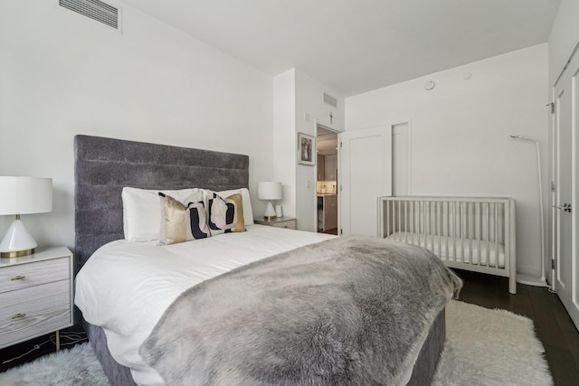 bedroom with dark hardwood / wood-style flooring