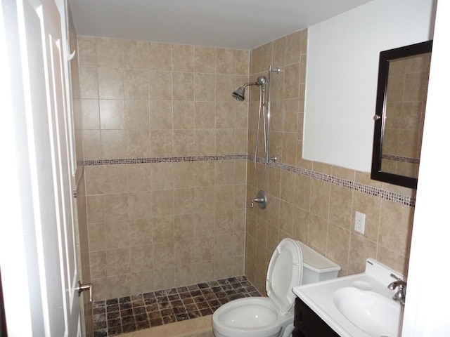 809 22nd St Unit 905, Union City, NJ 07087 - bathroom featuring a tile shower, vanity, toilet, and tile walls