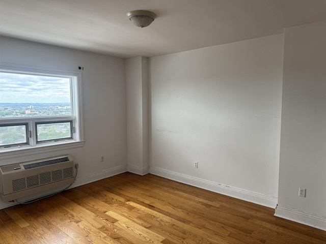 809 22nd St Unit 905, Union City, NJ 07087 - unfurnished room featuring a wall mounted air conditioner, light wood-style floors, and baseboards