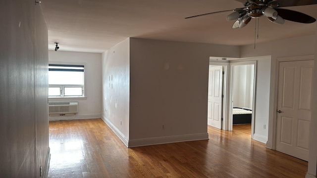 809 22nd St Unit 905, Union City, NJ 07087 - spare room featuring ceiling fan, an AC wall unit, wood finished floors, and baseboards