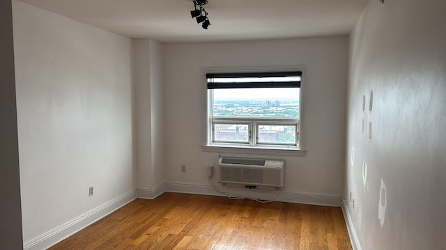 809 22nd St Unit 905, Union City, NJ 07087 - empty room with a wall unit AC, light wood finished floors, and baseboards