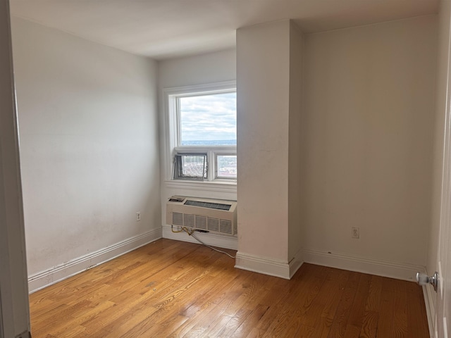 809 22nd St Unit 905, Union City, NJ 07087 - unfurnished room with a wall unit AC, light wood finished floors, and baseboards