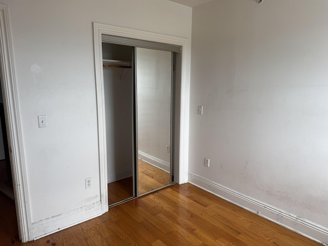 809 22nd St Unit 905, Union City, NJ 07087 - unfurnished bedroom featuring wood finished floors, a closet, and baseboards