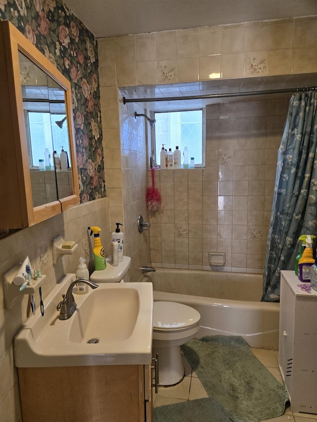 407 77th St, North Bergen, NJ 07047 - full bath featuring toilet, shower / bath combo with shower curtain, vanity, healthy amount of natural light, and tile walls