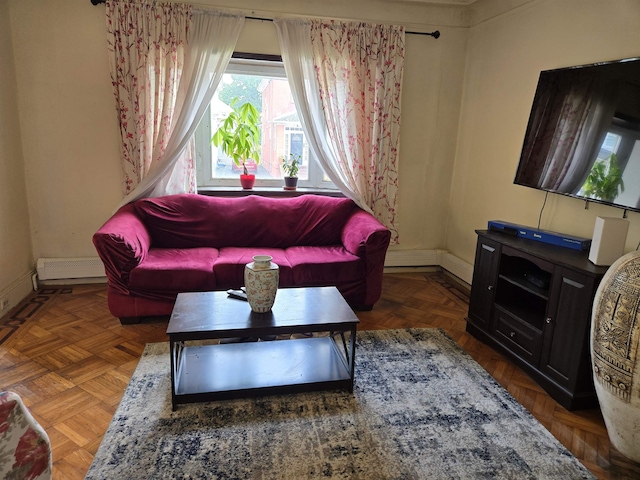407 77th St, North Bergen, NJ 07047 - living room featuring a baseboard radiator and baseboards