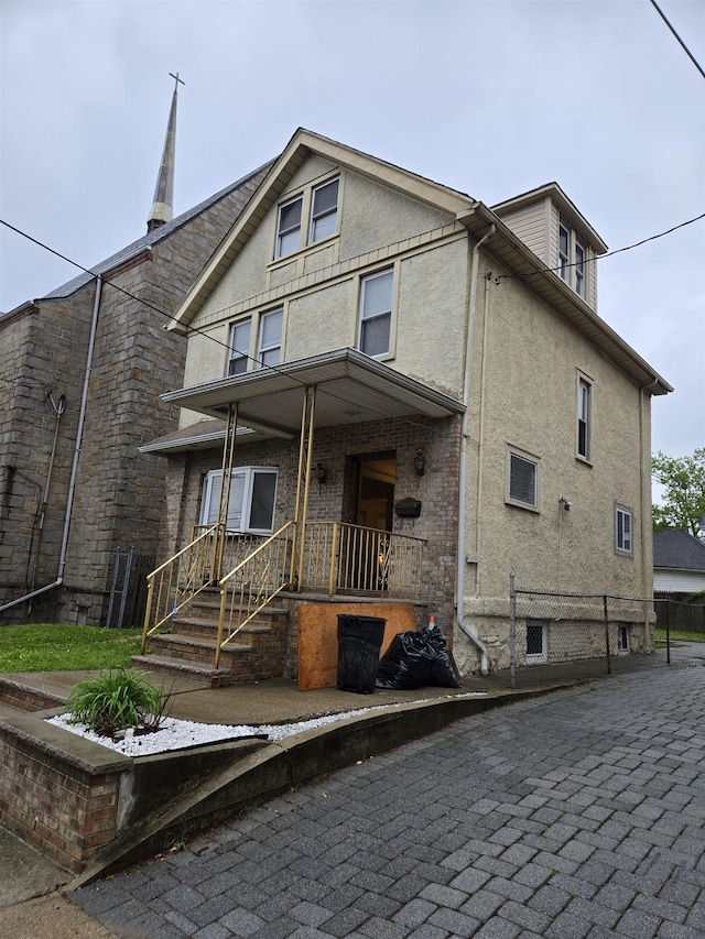 407 77th St, North Bergen, NJ 07047 - view of front of house with stucco siding