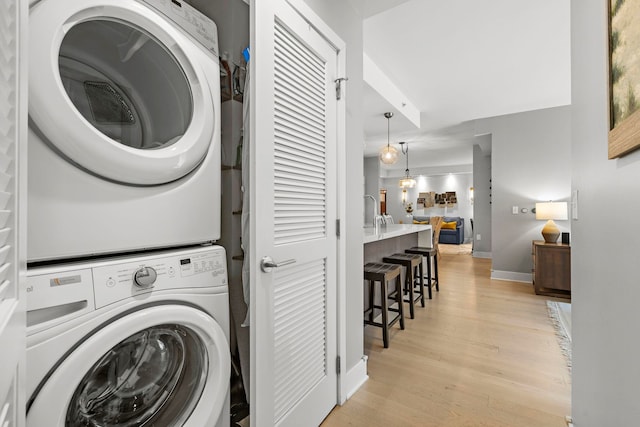 1400 Hudson St Unit 511, Hoboken, NJ 07030 - laundry area with stacked washer / dryer and light wood-type flooring