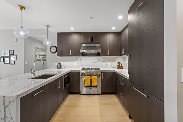 1400 Hudson St Unit 511, Hoboken, NJ 07030 - kitchen featuring high end range, under cabinet range hood, a peninsula, dark brown cabinetry, and recessed lighting