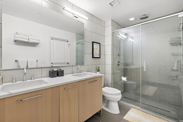1400 Hudson St Unit 511, Hoboken, NJ 07030 - bathroom with double vanity, a stall shower, tile patterned flooring, and tile walls