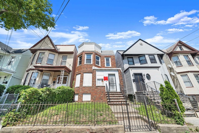 152 Bidwell Ave, Jersey City, NJ 07305 - view of front of property with a fenced front yard, a gate, and brick siding